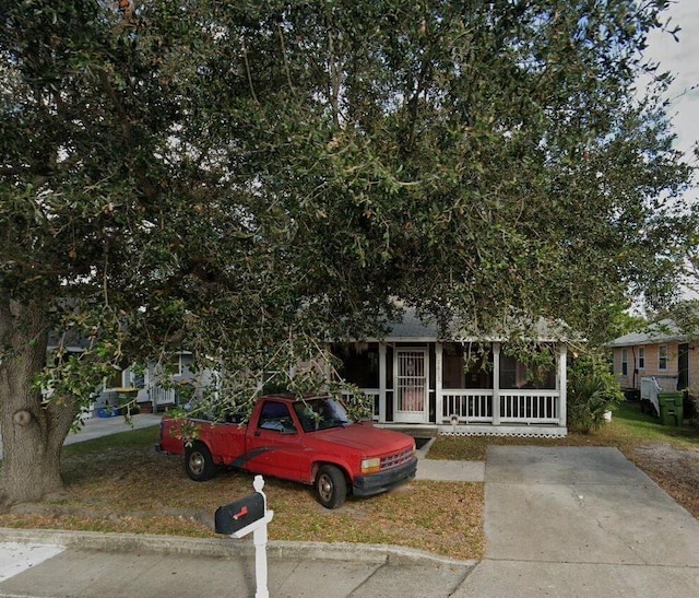 2012 Leon Ave, Sarasota, FL 34234 - view of property hidden behind natural elements featuring a porch