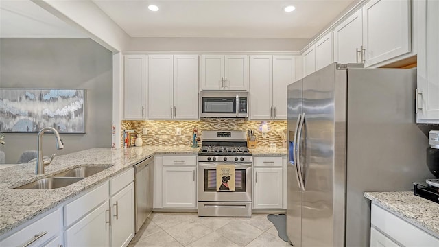 15160 Lyla Ter, Bradenton, FL 34211 - kitchen with appliances with stainless steel finishes, white cabinetry, decorative backsplash, and recessed lighting