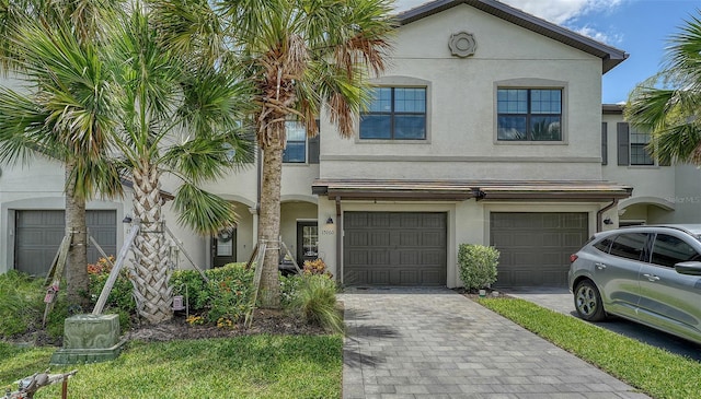 15160 Lyla Ter, Bradenton, FL 34211 - townhome / multi-family property featuring stucco siding, a garage, and driveway