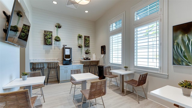 15160 Lyla Ter, Bradenton, FL 34211 - dining room featuring recessed lighting, light wood-style flooring, and wood walls