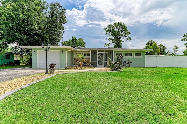 557 Reading St NW, Port Charlotte, FL 33952 - single story home featuring an attached garage, asphalt driveway, and concrete block siding