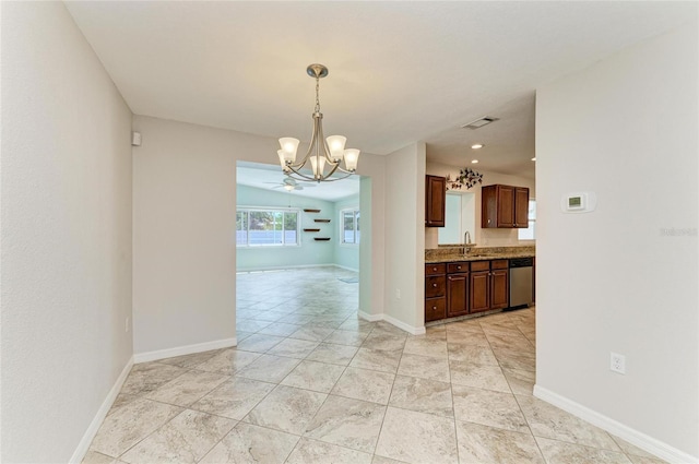557 Reading St NW, Port Charlotte, FL 33952 - spare room with a chandelier and baseboards