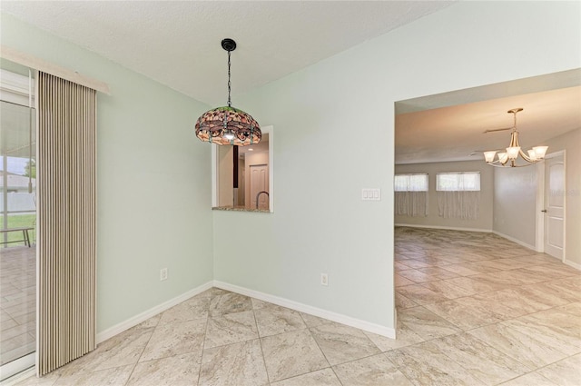557 Reading St NW, Port Charlotte, FL 33952 - spare room featuring a chandelier and baseboards