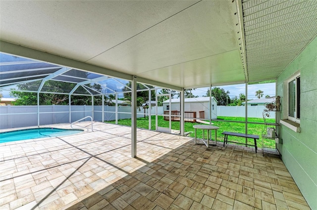 557 Reading St NW, Port Charlotte, FL 33952 - view of pool featuring a shed, a fenced backyard, a patio, and glass enclosure