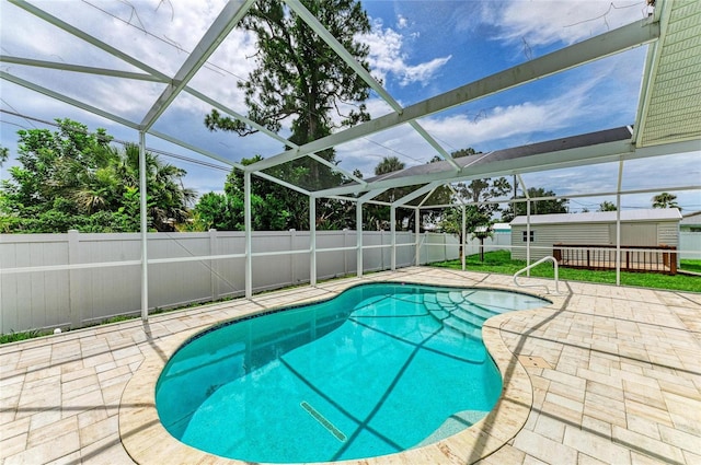 557 Reading St NW, Port Charlotte, FL 33952 - view of pool with a patio, a fenced backyard, a lanai, and a storage shed