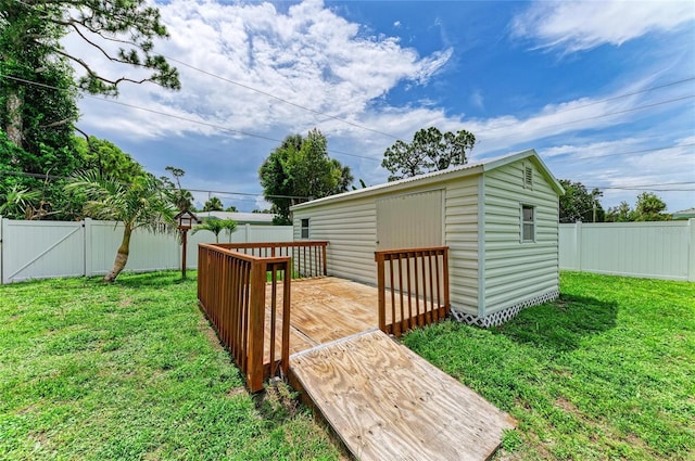 557 Reading St NW, Port Charlotte, FL 33952 - fenced backyard featuring a wooden deck and a storage unit