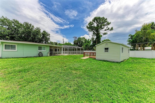 557 Reading St NW, Port Charlotte, FL 33952 - view of yard with a sunroom, an outdoor structure, and a deck