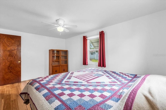 5401 Mac Arthur Ave, New Port Richey, FL 34652 - bedroom featuring wood finished floors and a ceiling fan