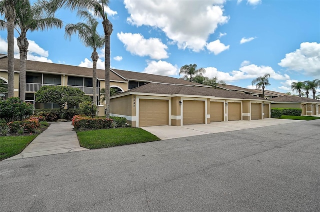 5240 Hyland Hills Ave Unit 1425, Sarasota, FL 34241 - view of front of house with community garages and stucco siding