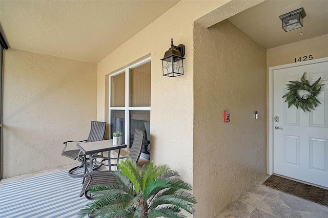 5240 Hyland Hills Ave Unit 1425, Sarasota, FL 34241 - view of exterior entry featuring stucco siding and covered porch