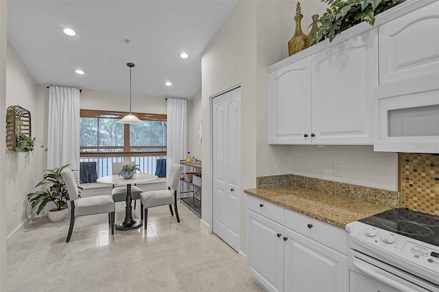 5240 Hyland Hills Ave Unit 1425, Sarasota, FL 34241 - kitchen with white appliances, white cabinetry, backsplash, light stone counters, and recessed lighting