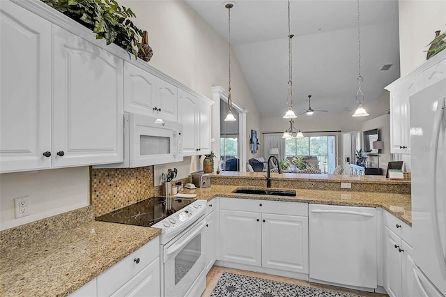 5240 Hyland Hills Ave Unit 1425, Sarasota, FL 34241 - kitchen with white appliances, high vaulted ceiling, white cabinetry, decorative light fixtures, and light stone countertops