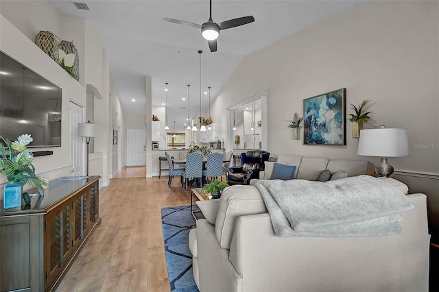 5240 Hyland Hills Ave Unit 1425, Sarasota, FL 34241 - living area with ceiling fan, light wood finished floors, and vaulted ceiling