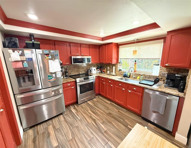 1502 Georgetowne Ln, Sarasota, FL 34232 - kitchen with stainless steel appliances, a tray ceiling, tasteful backsplash, light stone countertops, and recessed lighting