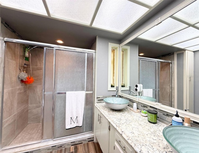 1502 Georgetowne Ln, Sarasota, FL 34232 - full bathroom with vanity, a stall shower, and recessed lighting
