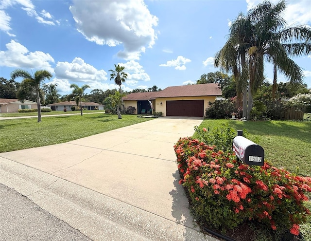 1502 Georgetowne Ln, Sarasota, FL 34232 - ranch-style home with an attached garage, driveway, a front lawn, and stucco siding