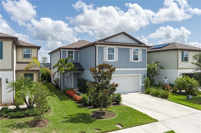 9144 Royal River Cir, Parrish, FL 34219 - view of front of house with concrete driveway, a garage, a front yard, and board and batten siding