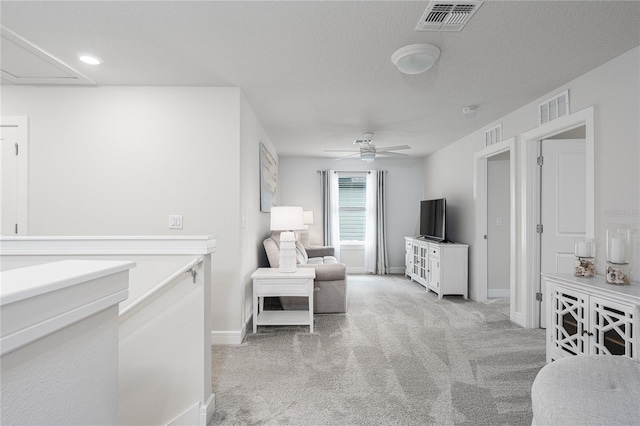 9144 Royal River Cir, Parrish, FL 34219 - living area featuring light colored carpet, attic access, ceiling fan, and a textured ceiling