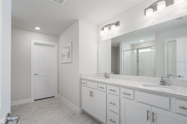 9144 Royal River Cir, Parrish, FL 34219 - bathroom featuring double vanity, a shower stall, and recessed lighting