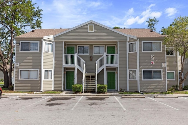 7298 Ulmerton Rd Unit 202, Largo, FL 33771 - view of property with uncovered parking and stairway