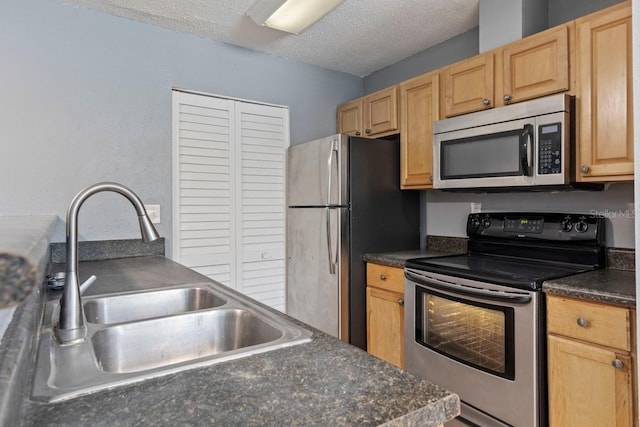 7298 Ulmerton Rd Unit 202, Largo, FL 33771 - kitchen with stainless steel appliances, dark countertops, light brown cabinetry, and a textured ceiling