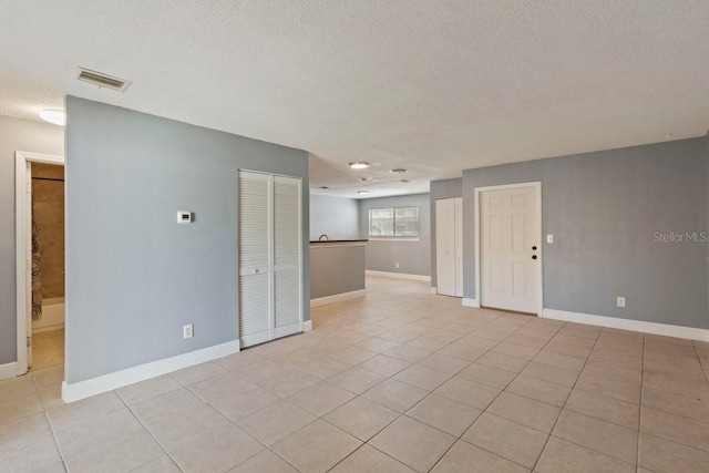 7298 Ulmerton Rd Unit 202, Largo, FL 33771 - empty room featuring a textured ceiling and light tile patterned flooring