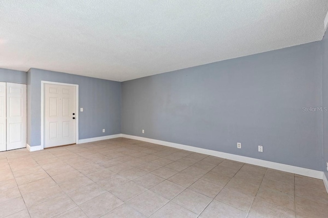 7298 Ulmerton Rd Unit 202, Largo, FL 33771 - empty room featuring a textured ceiling and light tile patterned flooring
