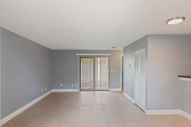 7298 Ulmerton Rd Unit 202, Largo, FL 33771 - unfurnished room with light tile patterned flooring and baseboards