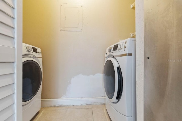 7298 Ulmerton Rd Unit 202, Largo, FL 33771 - washroom featuring electric panel, tile patterned floors, and separate washer and dryer