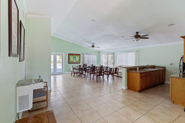 7298 Ulmerton Rd Unit 202, Largo, FL 33771 - dining room featuring a ceiling fan, light tile patterned flooring, crown molding, and lofted ceiling