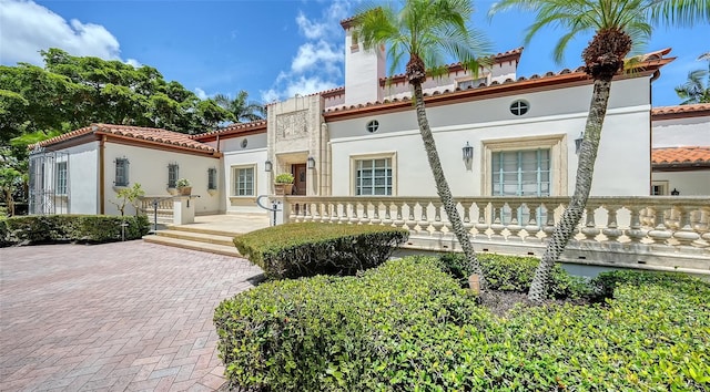 4423 Bay Shore Rd, Sarasota, FL 34234 - mediterranean / spanish-style house featuring stucco siding, a tile roof, and a chimney