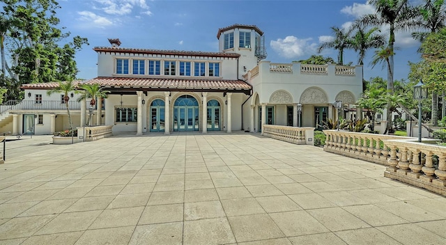 4423 Bay Shore Rd, Sarasota, FL 34234 - rear view of property with stucco siding, a tiled roof, a patio area, and french doors