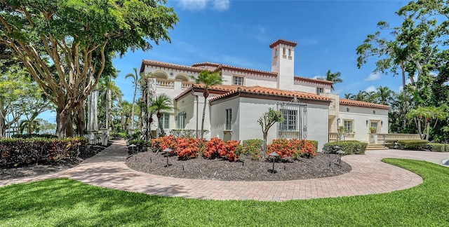 4423 Bay Shore Rd, Sarasota, FL 34234 - rear view of property featuring stucco siding, a chimney, and a tile roof