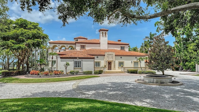 4423 Bay Shore Rd, Sarasota, FL 34234 - back of house featuring stucco siding, a tile roof, and a chimney