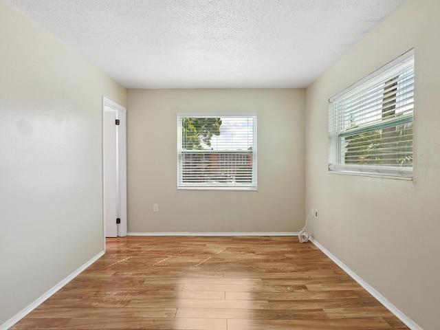 2423 Flamingo Blvd Unit K29, Bradenton, FL 34207 - spare room featuring healthy amount of natural light, light wood-style floors, and a textured ceiling