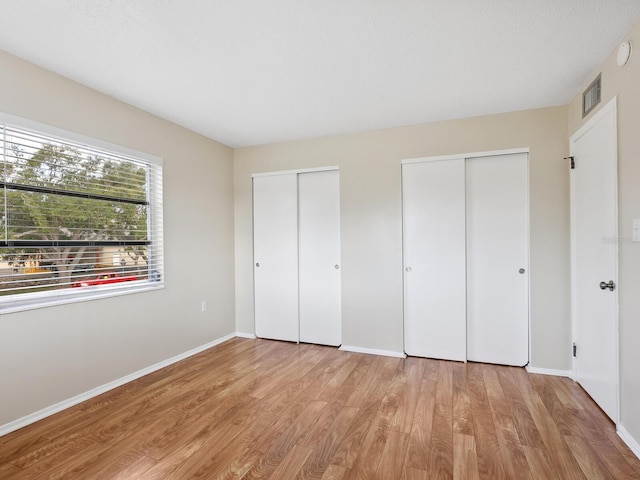 2423 Flamingo Blvd Unit K29, Bradenton, FL 34207 - unfurnished bedroom with multiple closets and wood finished floors