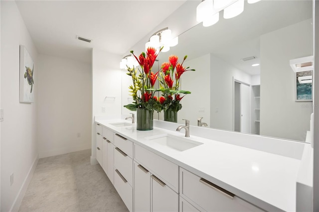 311 Island Cir, Sarasota, FL 34242 - bathroom featuring double vanity and baseboards