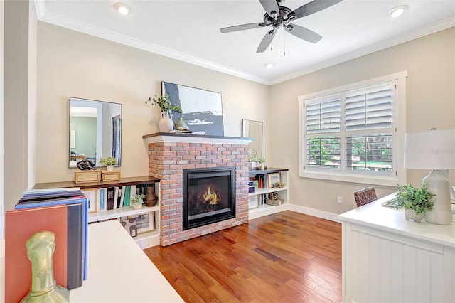 1906 143rd Ct E, Bradenton, FL 34212 - living room featuring ornamental molding, wood finished floors, a brick fireplace, a ceiling fan, and recessed lighting