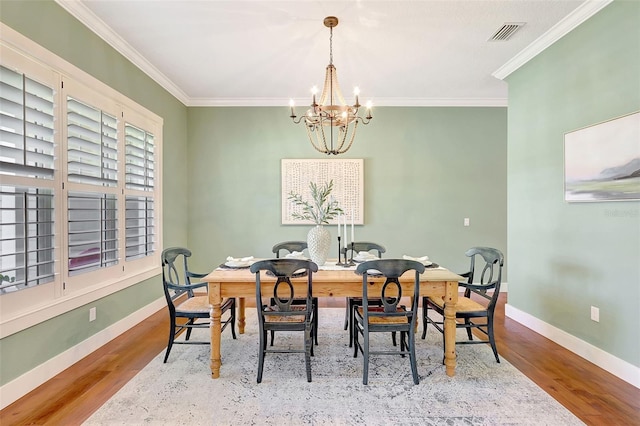 1906 143rd Ct E, Bradenton, FL 34212 - dining area featuring a chandelier, ornamental molding, and wood finished floors