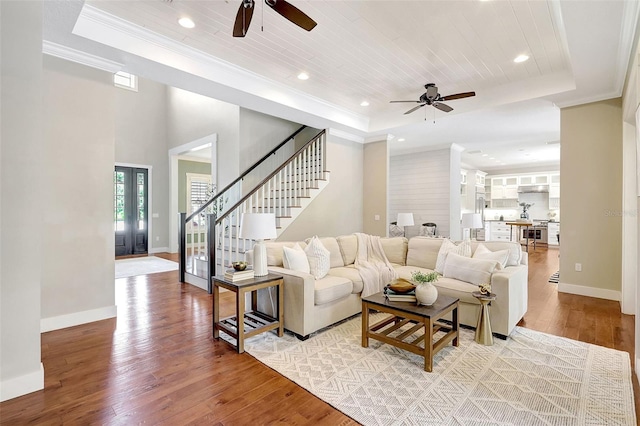 1906 143rd Ct E, Bradenton, FL 34212 - living room featuring a tray ceiling, ceiling fan, light wood-style floors, stairs, and recessed lighting