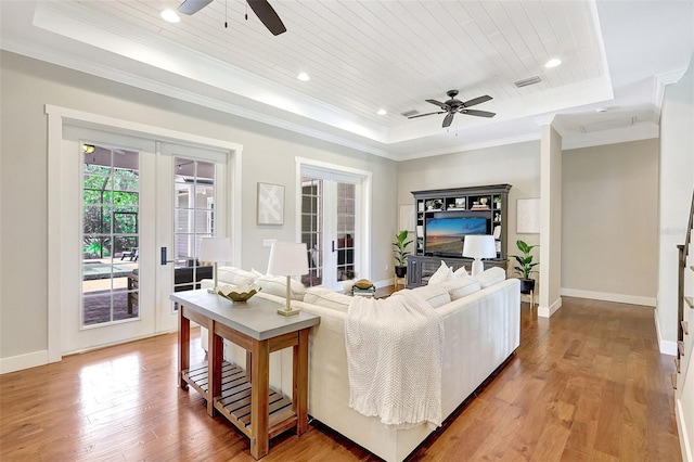 1906 143rd Ct E, Bradenton, FL 34212 - living area featuring a tray ceiling, a ceiling fan, french doors, light wood finished floors, and crown molding
