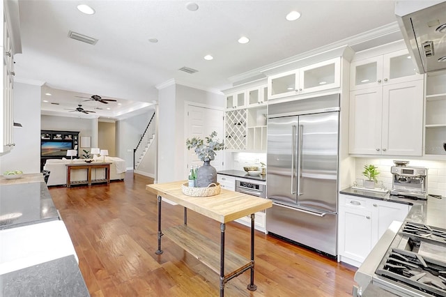 1906 143rd Ct E, Bradenton, FL 34212 - kitchen with stainless steel built in fridge, crown molding, recessed lighting, and white cabinets