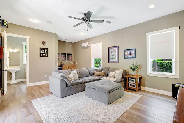 1906 143rd Ct E, Bradenton, FL 34212 - living room with light wood-style flooring, a wall mounted AC, a ceiling fan, and recessed lighting
