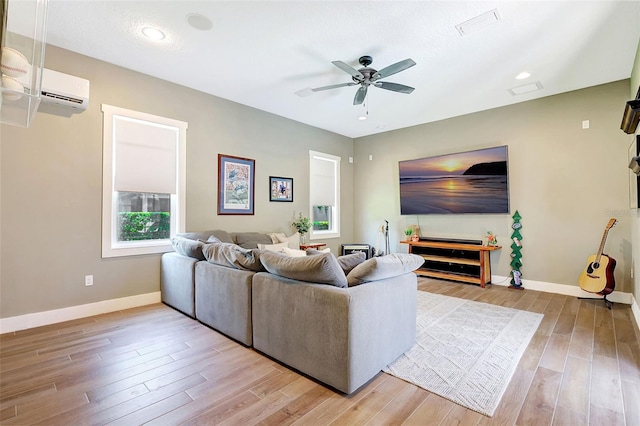 1906 143rd Ct E, Bradenton, FL 34212 - living room with ceiling fan, light wood finished floors, and an AC wall unit