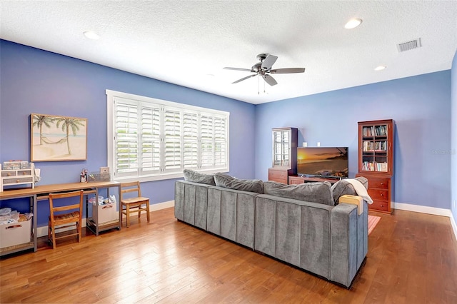 1906 143rd Ct E, Bradenton, FL 34212 - living area with a ceiling fan, wood finished floors, a textured ceiling, and recessed lighting