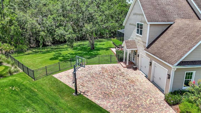 1906 143rd Ct E, Bradenton, FL 34212 - fenced backyard featuring decorative driveway, a garage, and a patio