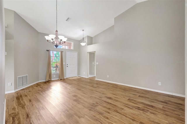 4539 Cabbage Key Ter, Bradenton, FL 34203 - spare room with a chandelier, light wood-style flooring, and high vaulted ceiling