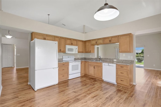 4539 Cabbage Key Ter, Bradenton, FL 34203 - kitchen featuring white appliances, light wood finished floors, vaulted ceiling, and pendant lighting