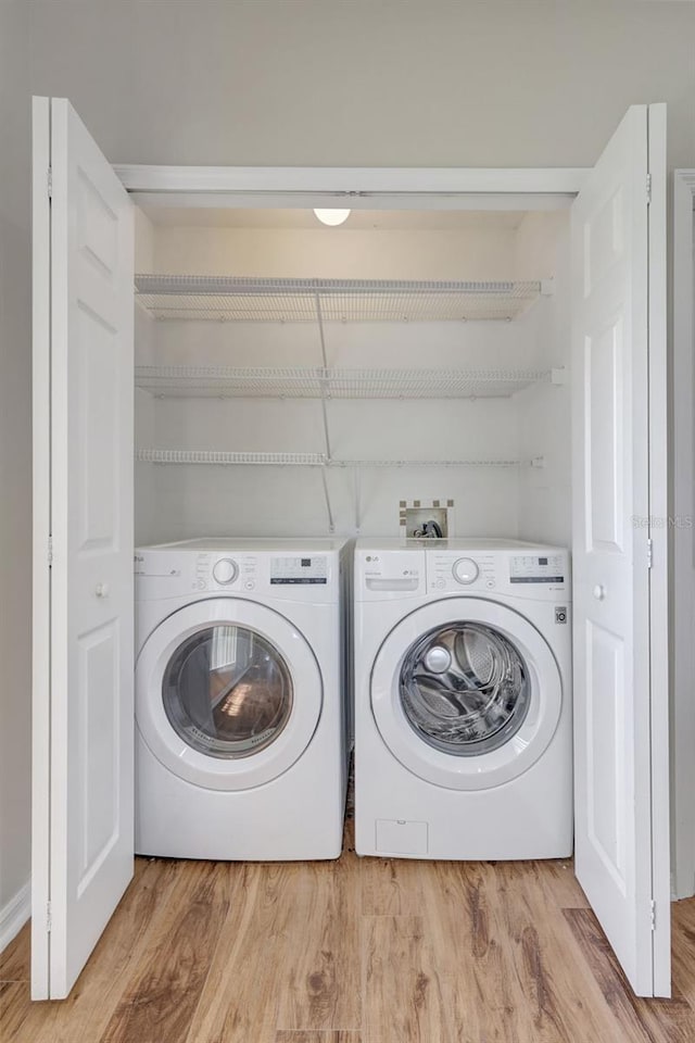 4539 Cabbage Key Ter, Bradenton, FL 34203 - washroom with light wood-type flooring and separate washer and dryer