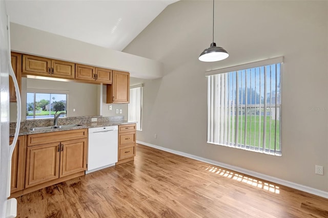 4539 Cabbage Key Ter, Bradenton, FL 34203 - kitchen with white appliances, light wood-style floors, high vaulted ceiling, decorative light fixtures, and light stone counters